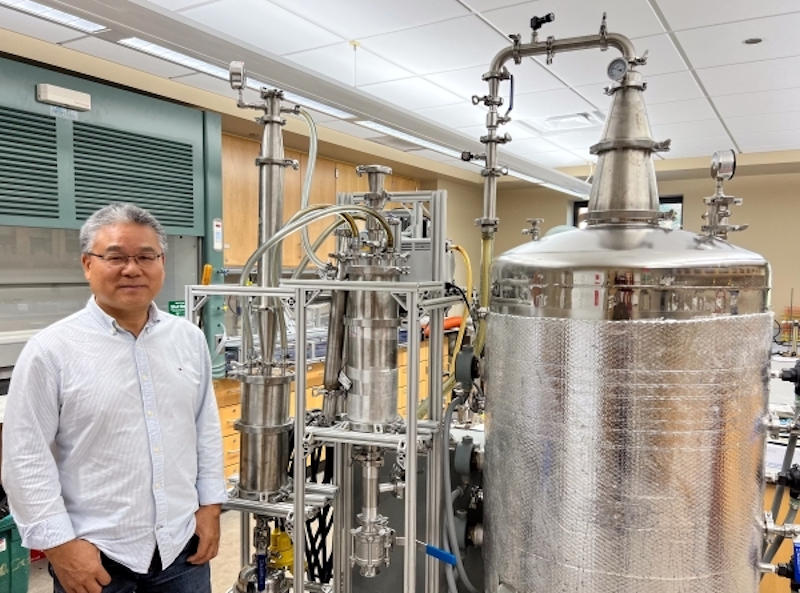 ESF Professor Wendong Tao, PhD standing in lab with tanks and piping